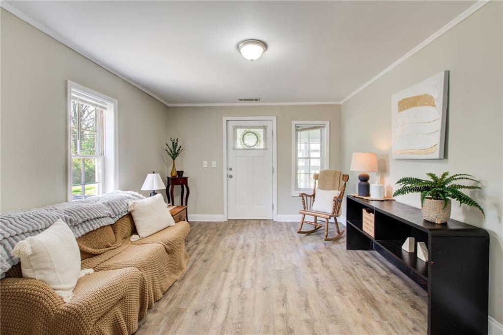 411 Ash Street Monroe, GA 30655 - Photo 5 of 36 a bed room with a bed and a potted plant