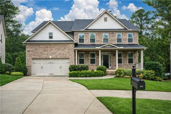 a front view of a house with a yard and garage