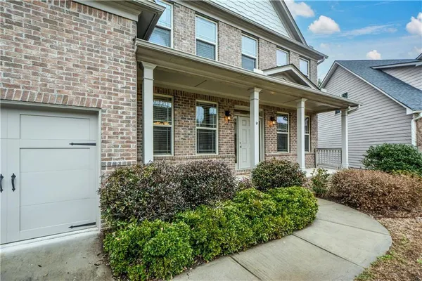 front view of a brick house with a large window