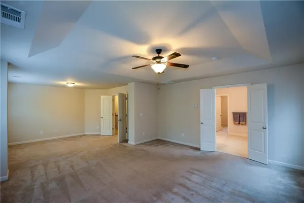 a view of an empty room with a ceiling fan