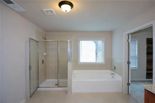 a bathroom with a tub shower and sink