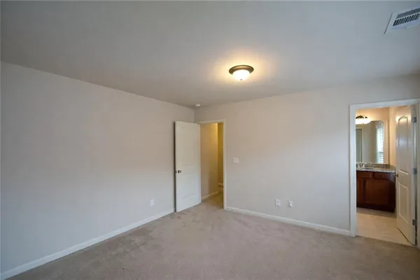 an empty room with an entrance and car parked