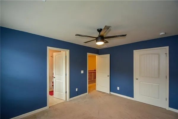 a view of a livingroom with a ceiling fan and window
