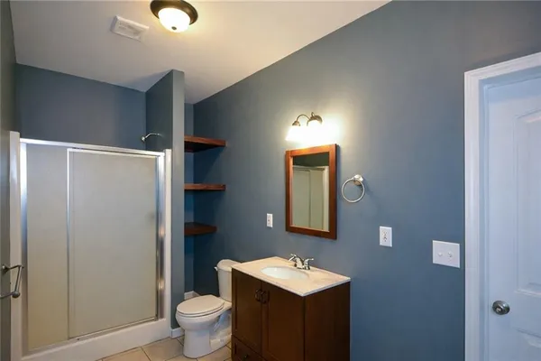 a bathroom with a toilet a sink and mirror