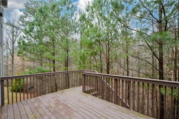 a view of balcony with wooden floor and fence