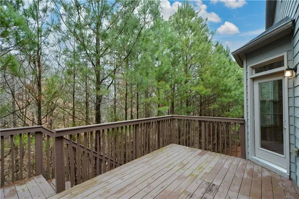 a balcony with wooden floor and fence
