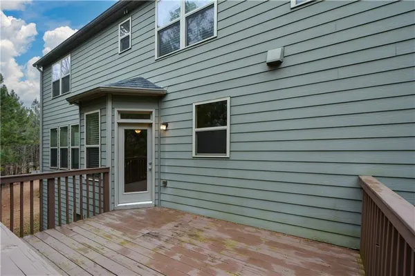 a view of a house with wooden deck
