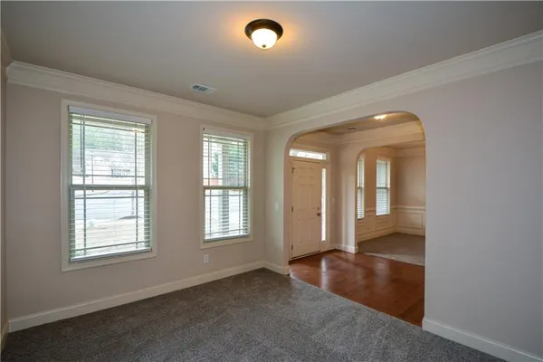 an empty room with windows and closet