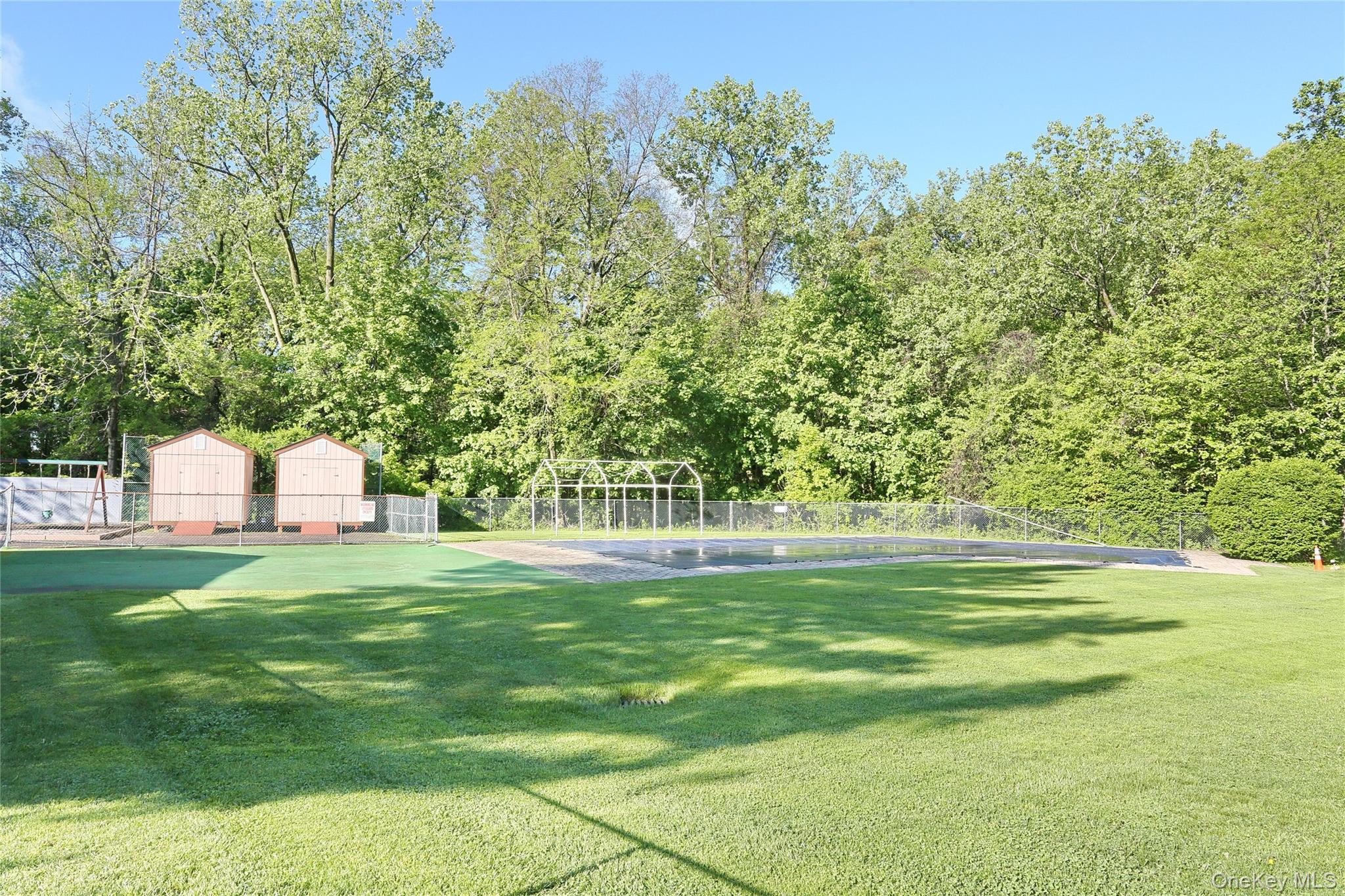 5 Secora Road, Unit F7 Spring Valley, NY 10977 - Photo 19 of 21 a front view of a house with a yard and trees