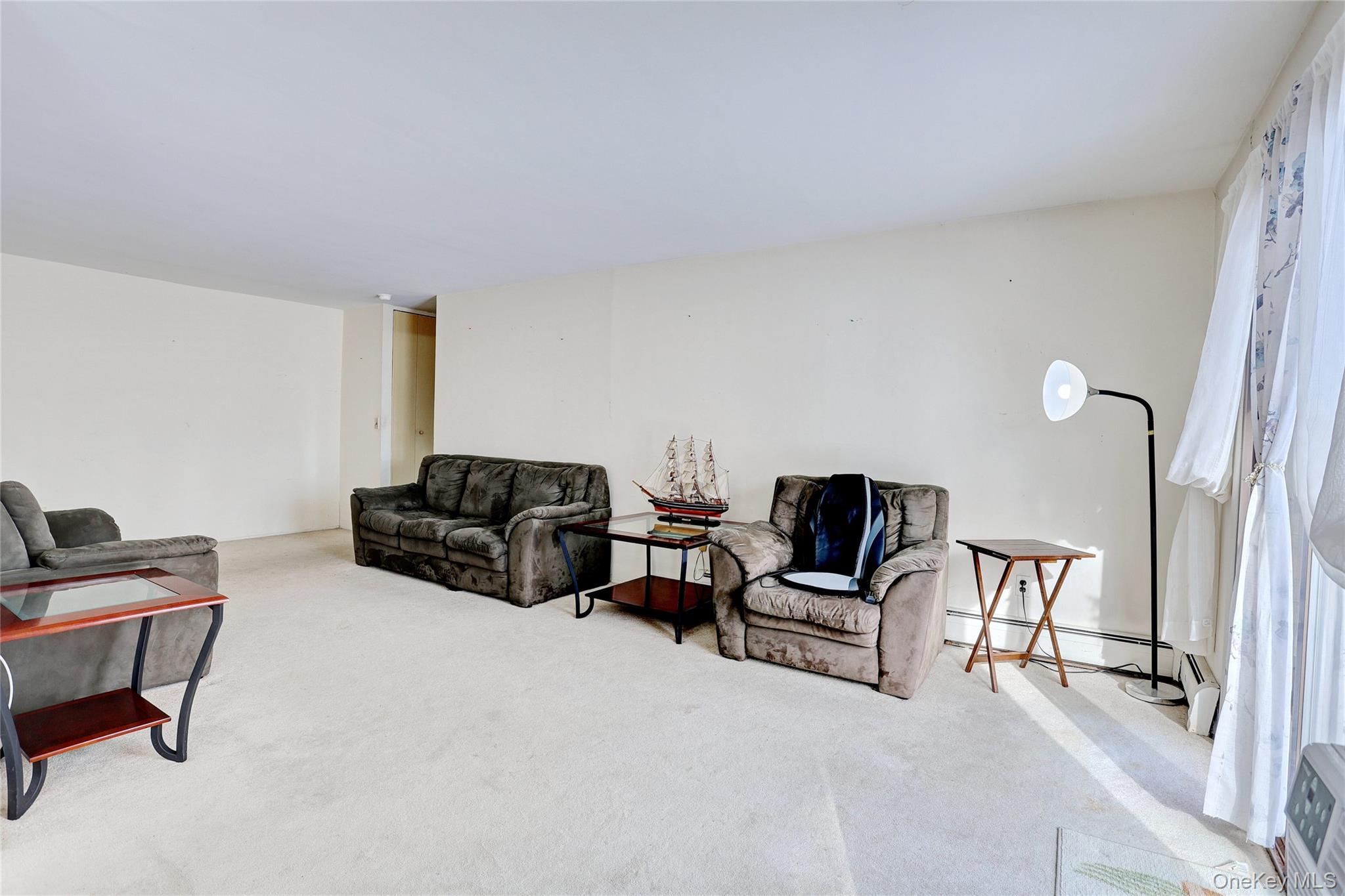 5 Secora Road, Unit F7 Spring Valley, NY 10977 - Photo 8 of 21 a living room with furniture and a piano
