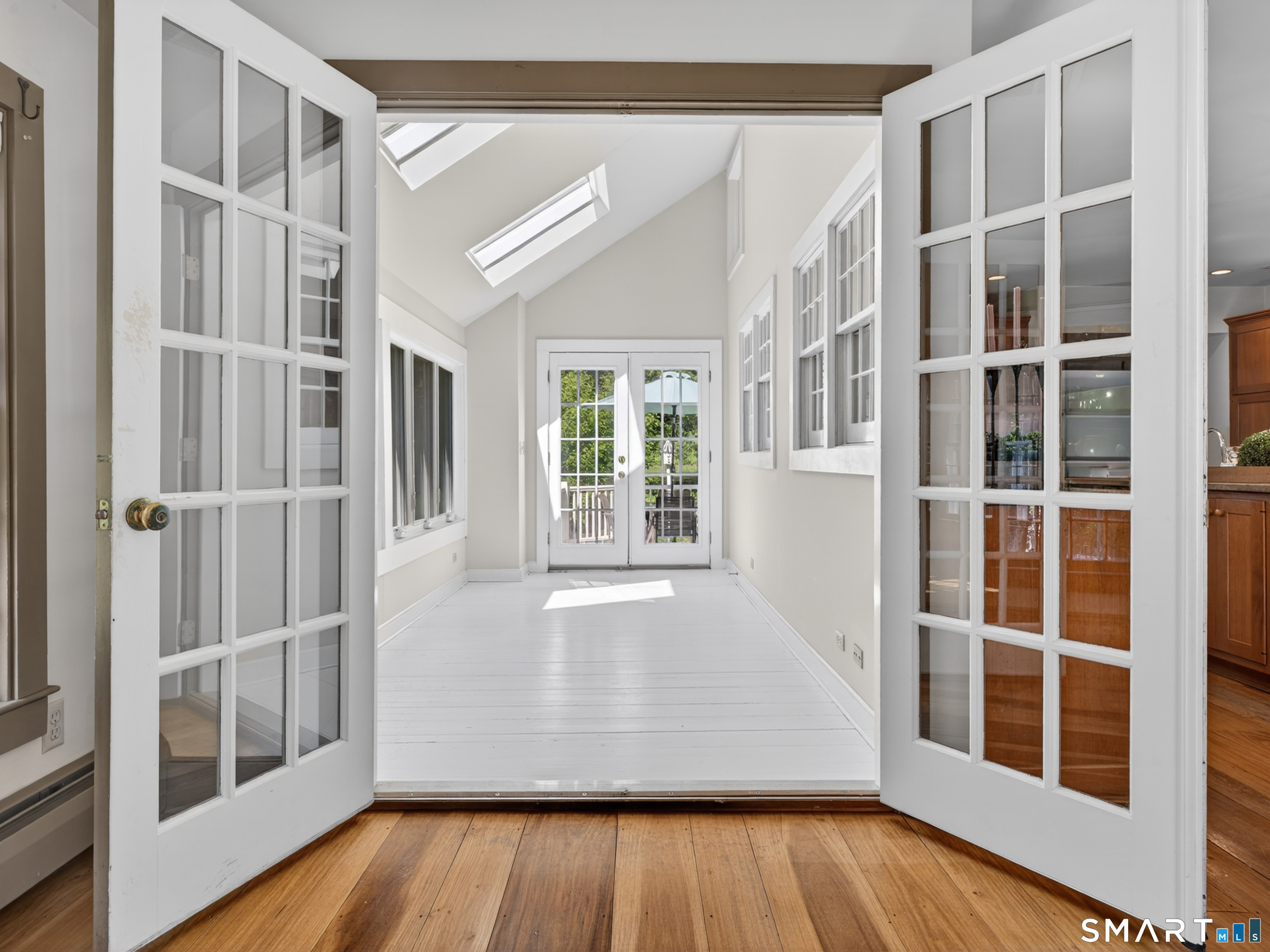14 Cow Pen Hill Road Killingworth, CT 06419 - Photo 26 of 40 Bathed in natural light from overhead skylights, the sunroom offers a bright and inviting space to relax, unwind, and enjoy views of the surrounding property year-round