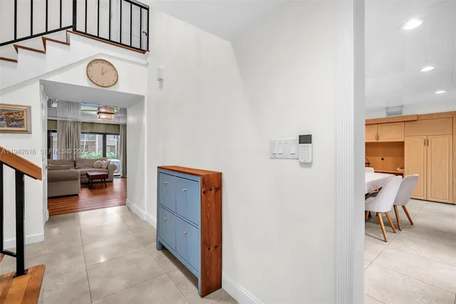 a living room with furniture a large window and a flat screen tv