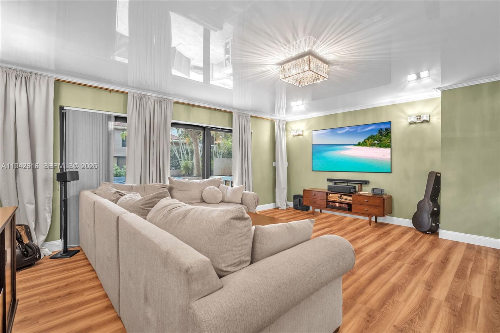 107 Heatherbrook Way, Unit 145 Hollywood, FL 33021 - Photo 13 of 57 a living room with furniture a large window and a flat screen tv