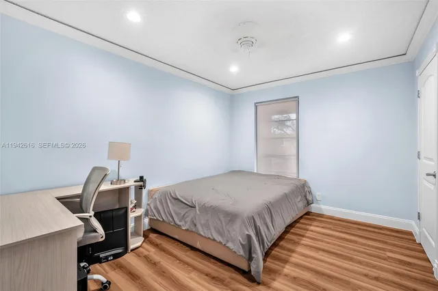 a view of a kitchen with white cabinets and a refrigerator