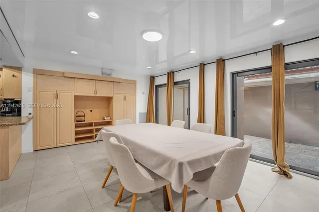 a large kitchen with a table and chairs in it