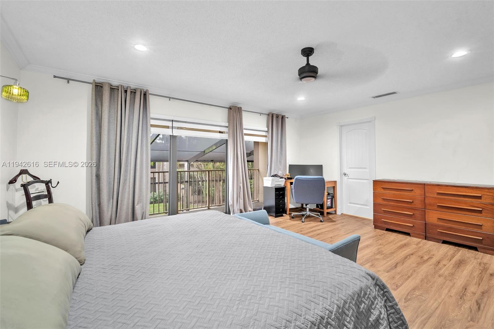 107 Heatherbrook Way, Unit 145 Hollywood, FL 33021 - Photo 23 of 57 a bed room with a bed and a large window