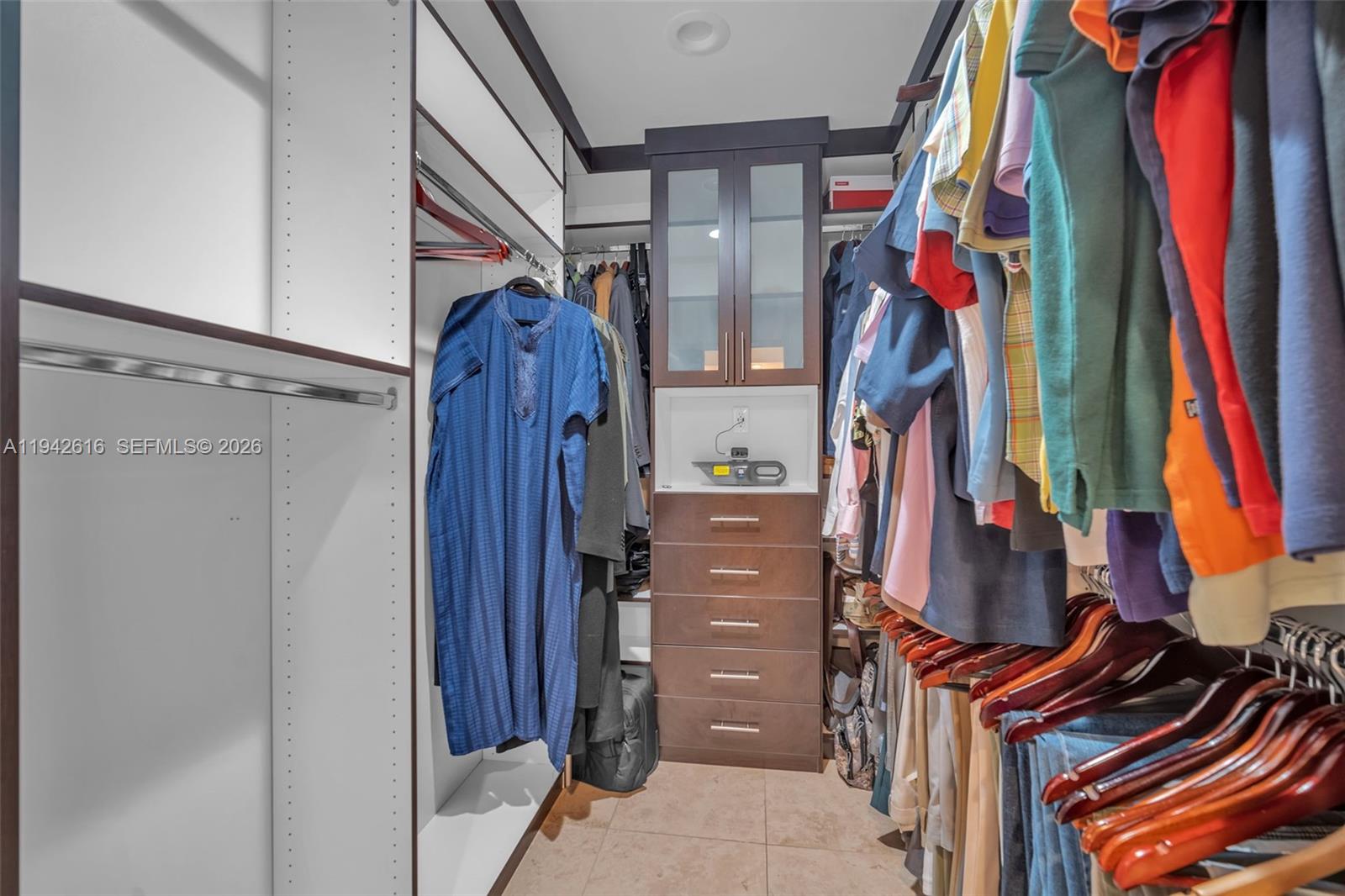 107 Heatherbrook Way, Unit 145 Hollywood, FL 33021 - Photo 24 of 57 a view of walk in closet with clothes and shoes