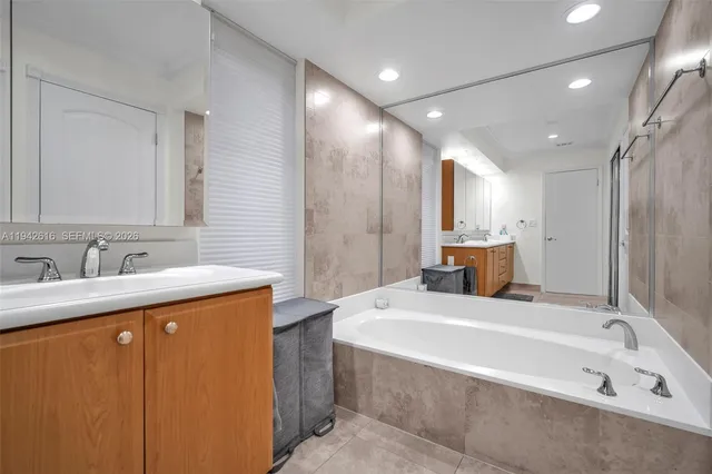 a bathroom with a double vanity sink and mirror