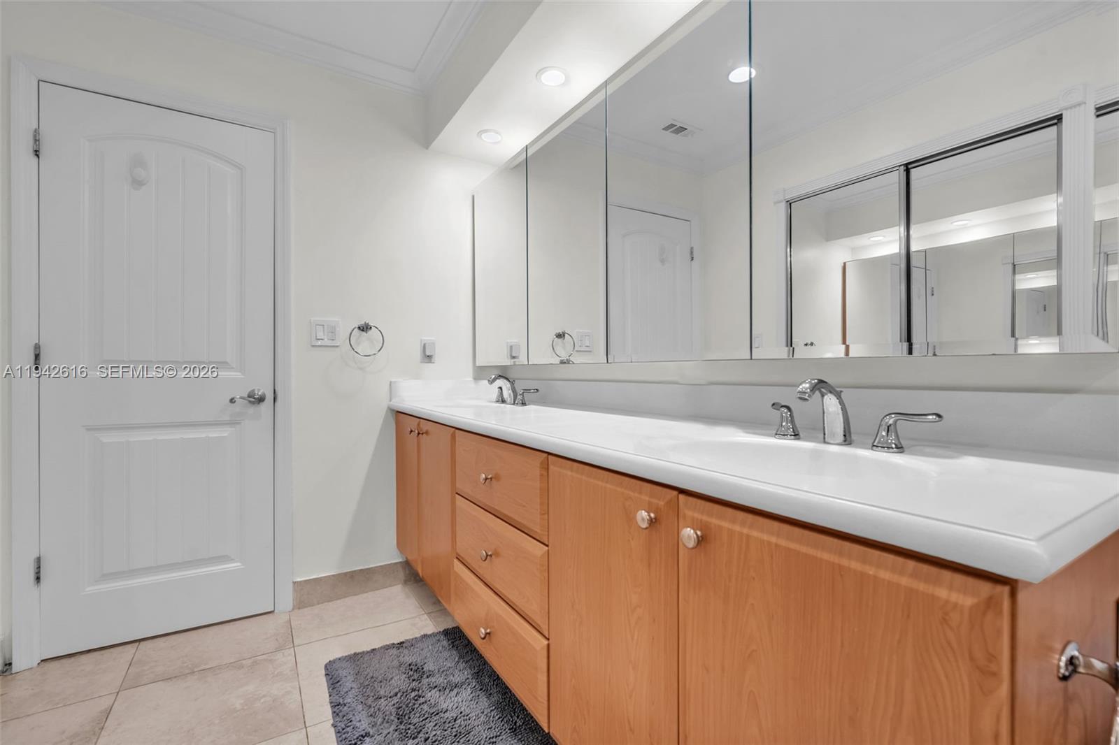 107 Heatherbrook Way, Unit 145 Hollywood, FL 33021 - Photo 28 of 57 a bathroom with a double vanity sink and mirror