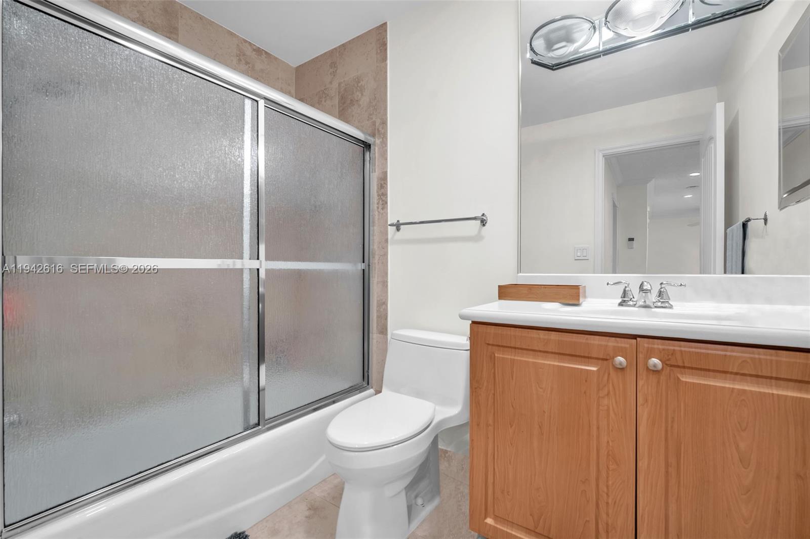 107 Heatherbrook Way, Unit 145 Hollywood, FL 33021 - Photo 29 of 57 a bathroom with a granite countertop sink toilet and shower