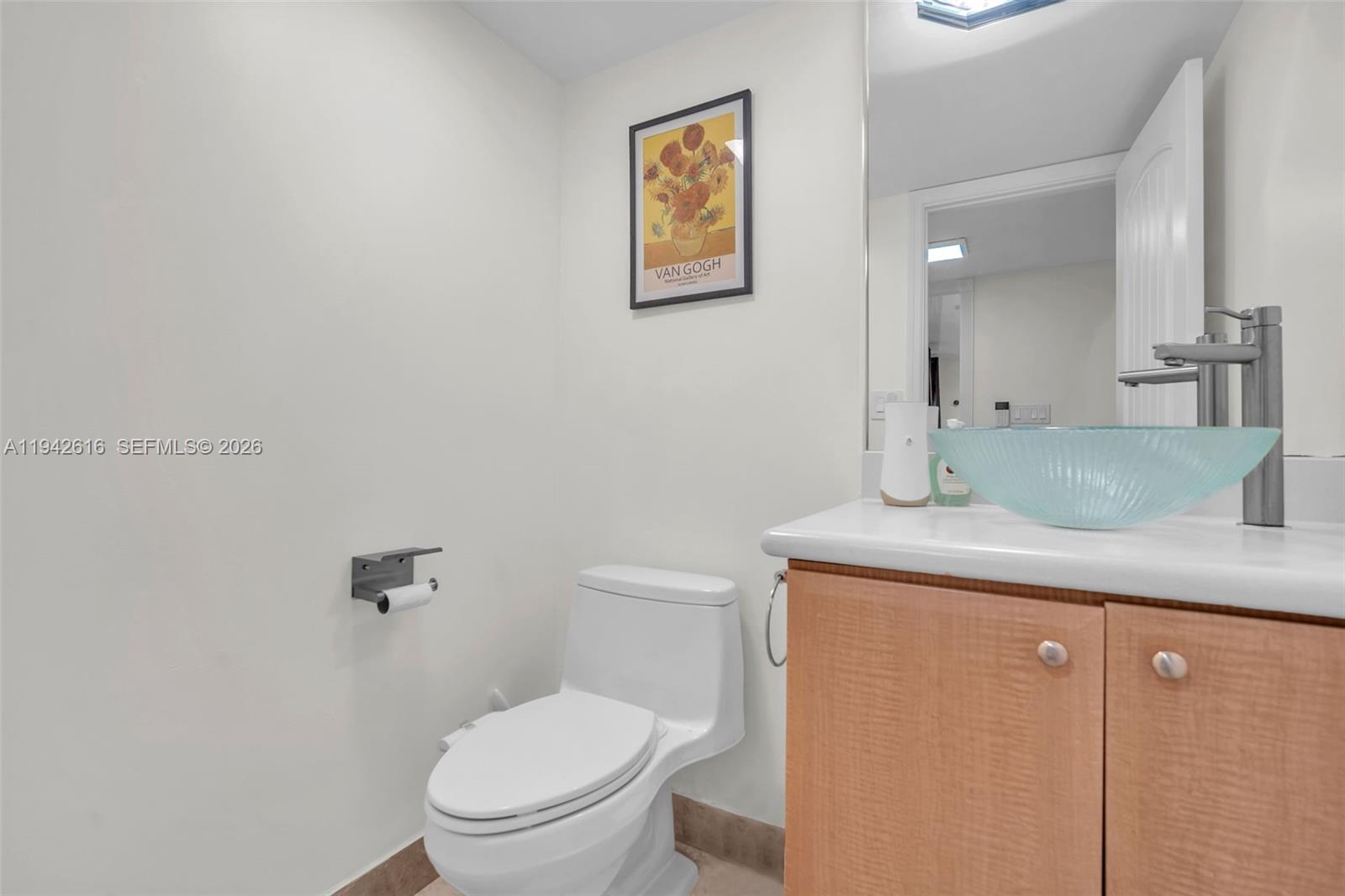 107 Heatherbrook Way, Unit 145 Hollywood, FL 33021 - Photo 30 of 57 a bathroom with a granite countertop toilet sink and mirror