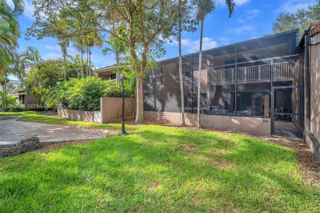 a view of a backyard with a tree