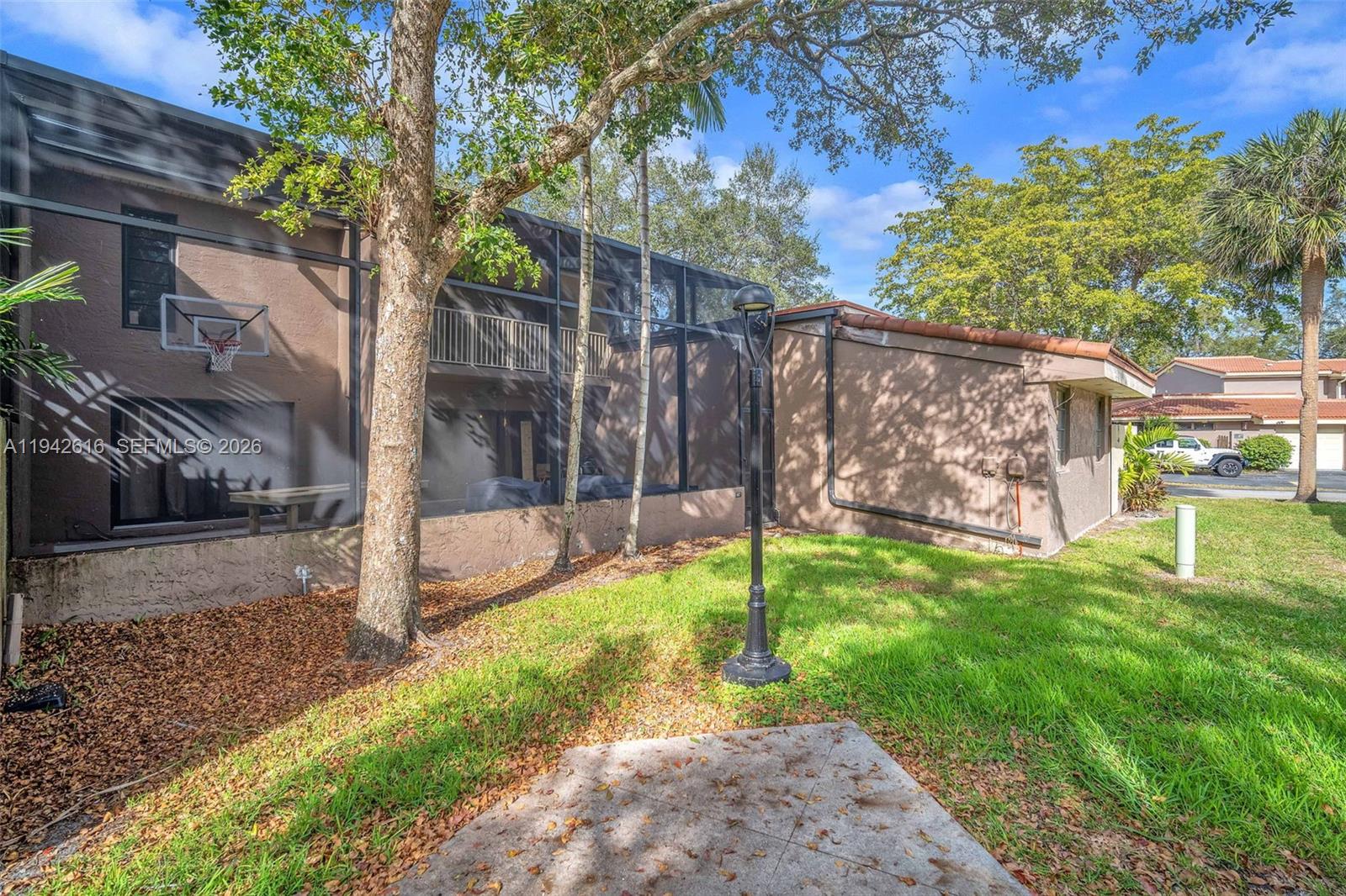 107 Heatherbrook Way, Unit 145 Hollywood, FL 33021 - Photo 36 of 57 a view of a backyard with a tree