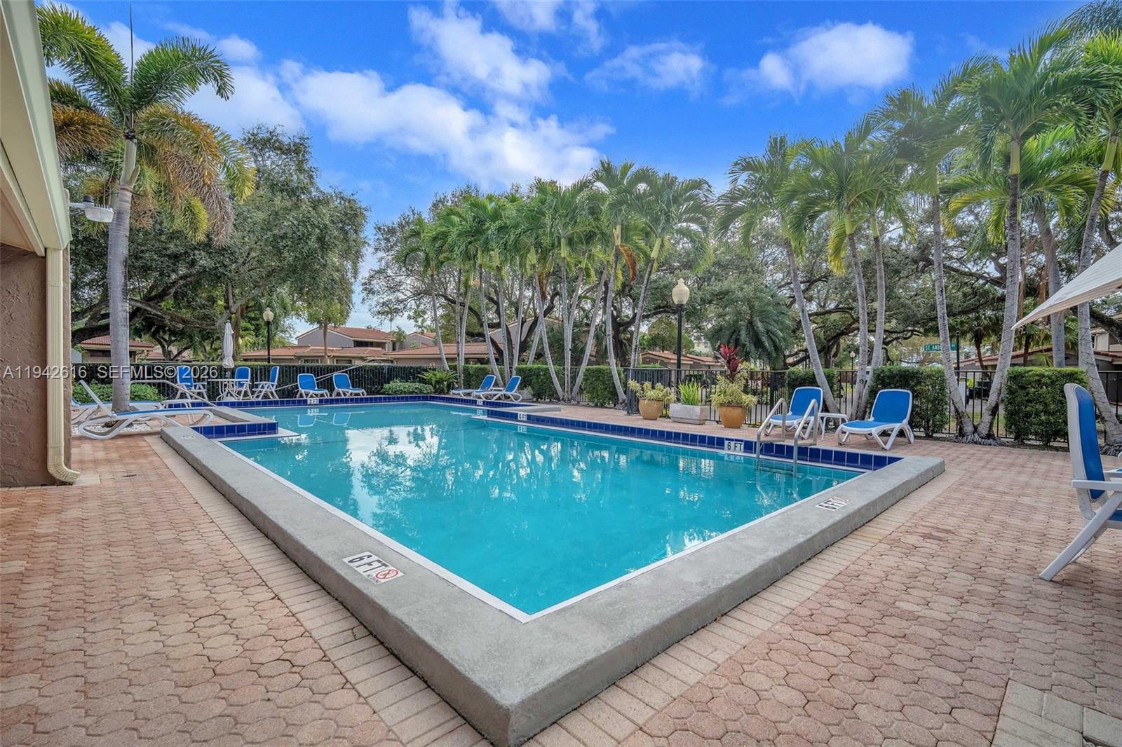 107 Heatherbrook Way, Unit 145 Hollywood, FL 33021 - Photo 43 of 57 a view of a swimming pool with a patio