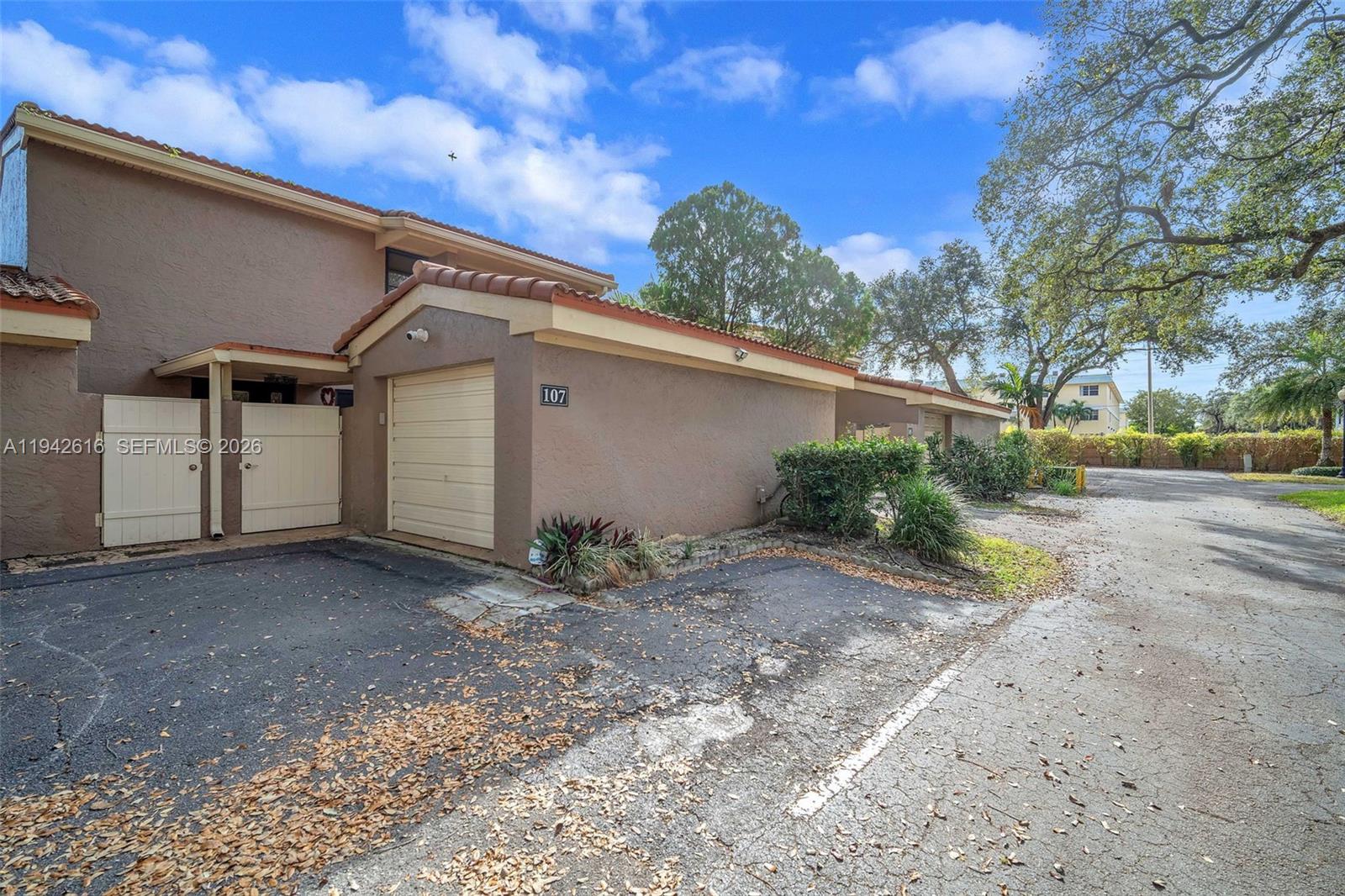 107 Heatherbrook Way, Unit 145 Hollywood, FL 33021 - Photo 47 of 57 a house with trees in front of it
