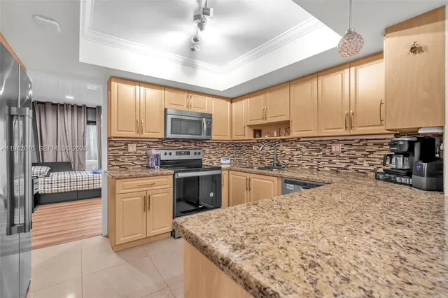 a kitchen with granite countertop white cabinets and white appliances
