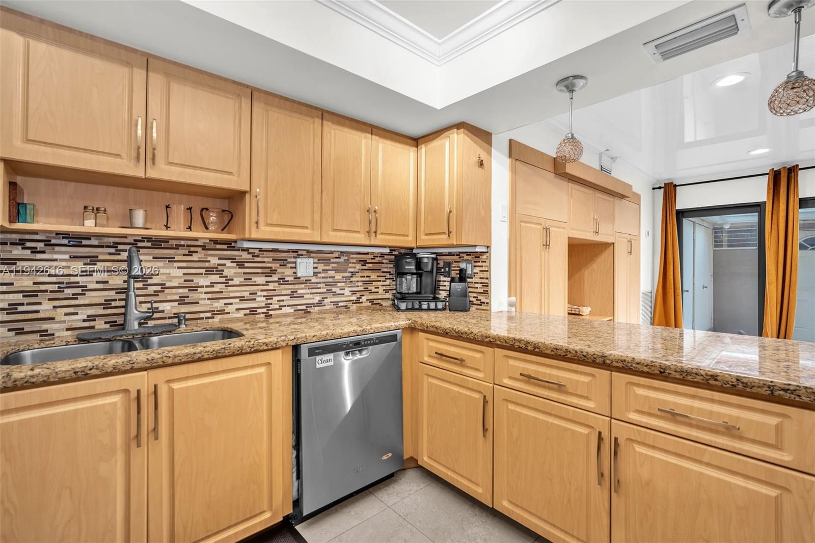 107 Heatherbrook Way, Unit 145 Hollywood, FL 33021 - Photo 7 of 57 a kitchen with granite countertop white cabinets and white appliances