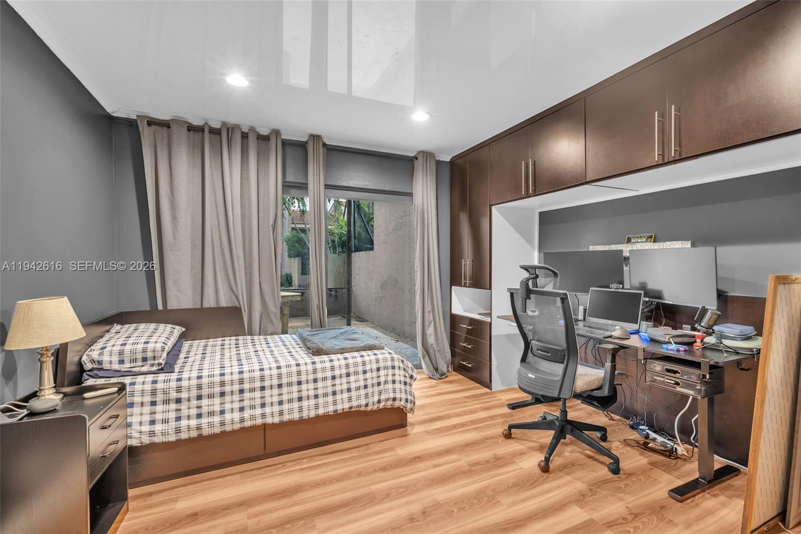 107 Heatherbrook Way, Unit 145 Hollywood, FL 33021 - Photo 10 of 57 a bedroom with a bed and a desk in it