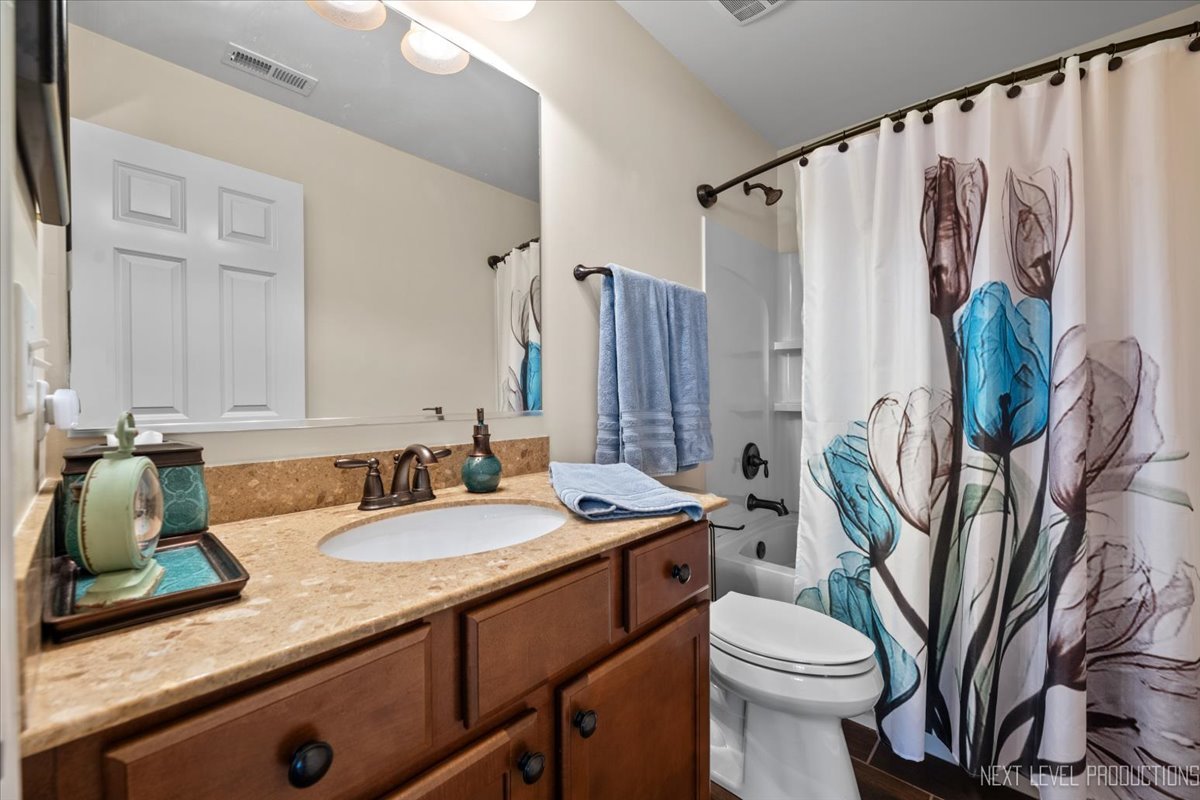 331 Bennett Drive Carol Stream, IL 60188 - Photo 18 of 22 a bathroom with a granite countertop sink a toilet and a shower
