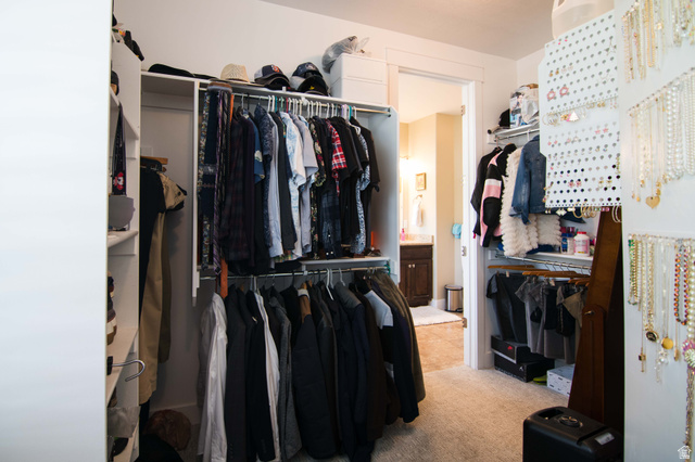 646 East 1400th Street North Mapleton, UT 84664 - Photo 29 of 78 Walk-in closet featuring white built-in shelving, multiple clothing rods, and carpet flooring