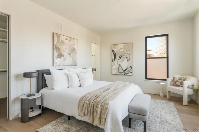 a bedroom with a bed and glass windows