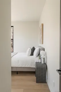 a bedroom with a bed and a window