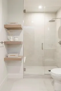 a bathroom with a shower a toilet and a shower