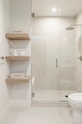a bathroom with a shower a toilet and a shower