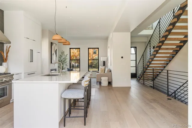 a living room with furniture a table and a large window