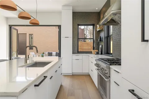 a kitchen with stainless steel appliances granite countertop a sink and stove