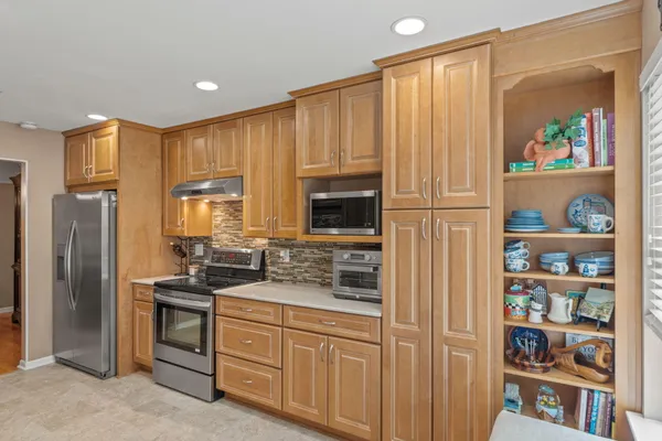 a kitchen with stainless steel appliances granite countertop a refrigerator and a sink