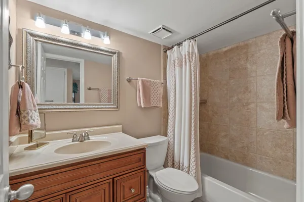 a living room with furniture a chandelier fan and a window