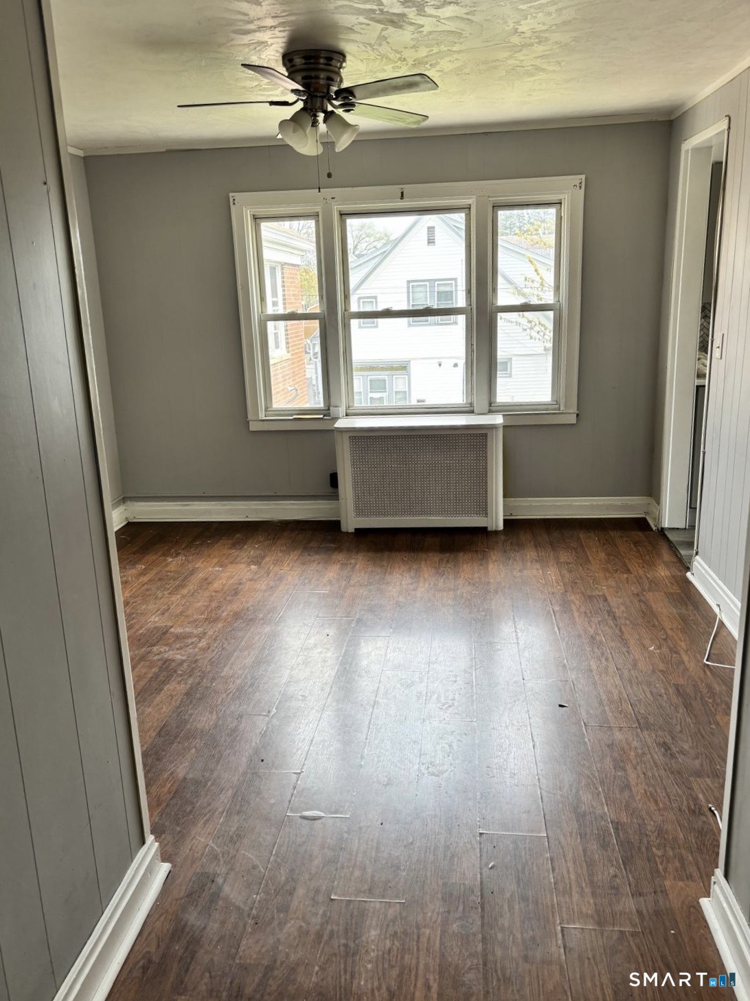 744 Canaan Road, Unit 23 Bridgeport, CT 06610 - Photo 4 of 12 a view of an empty room with wooden floor and a window
