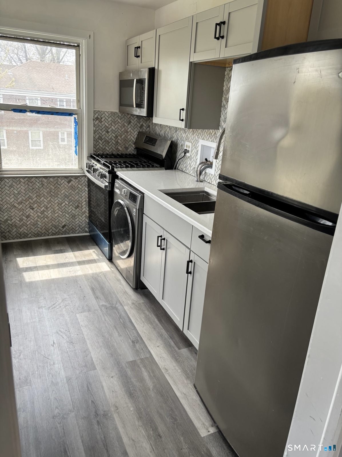 744 Canaan Road, Unit 23 Bridgeport, CT 06610 - Photo 6 of 12 a utility room with washer and dryer