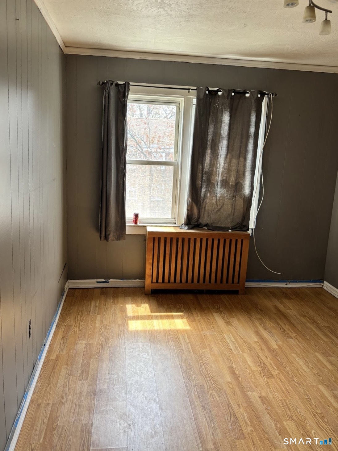 744 Canaan Road, Unit 23 Bridgeport, CT 06610 - Photo 8 of 12 an empty room with wooden floor and windows