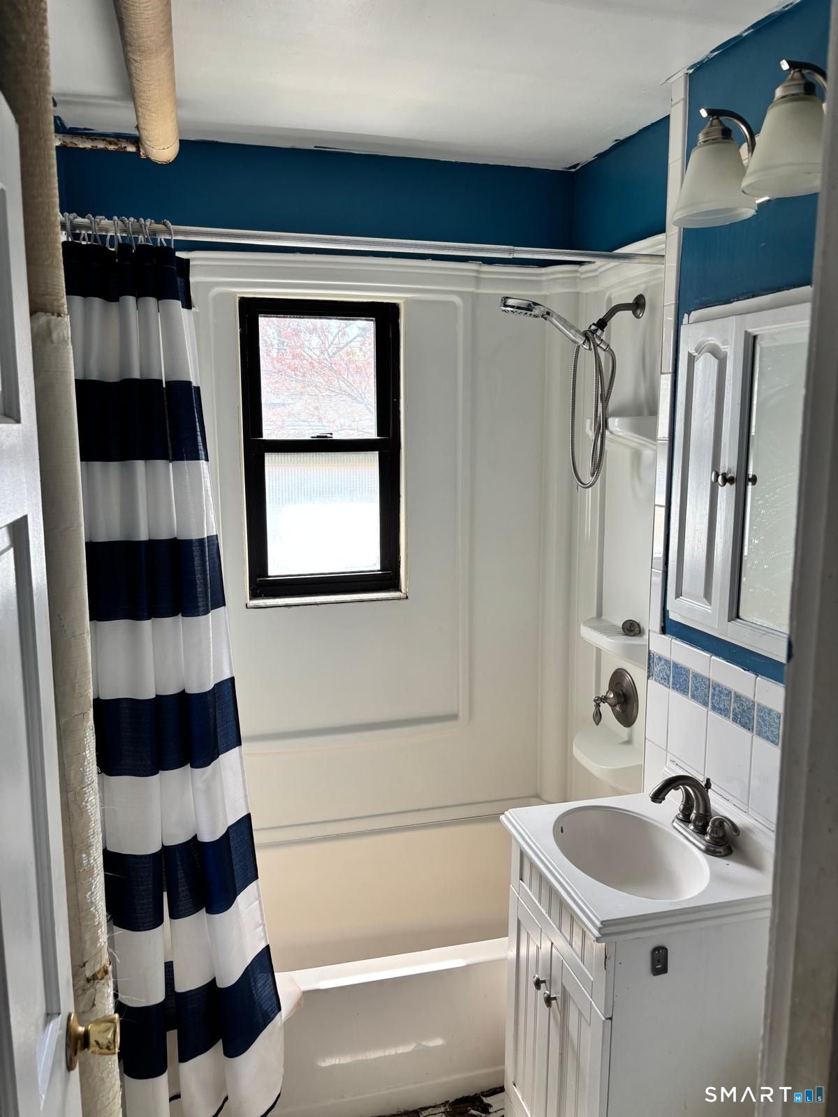 744 Canaan Road, Unit 23 Bridgeport, CT 06610 - Photo 9 of 12 a bathroom with a sink a toilet a shower and a mirror