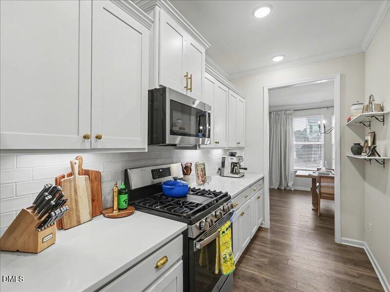 724 Summer Music Lane Raleigh, NC 27603 - Photo 13 of 70 a kitchen with stainless steel appliances granite countertop a stove a sink and a refrigerator