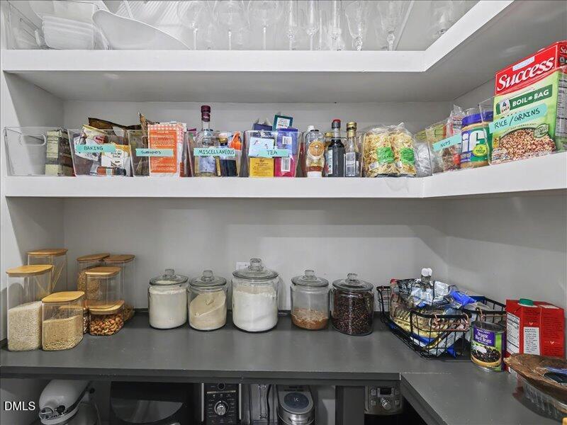 724 Summer Music Lane Raleigh, NC 27603 - Photo 17 of 70 a cabinet with white cabinets and potted plants on it