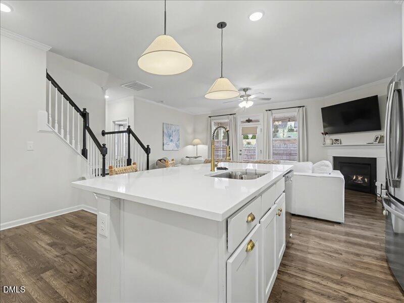 724 Summer Music Lane Raleigh, NC 27603 - Photo 18 of 70 a view of living room kitchen with a sink and fireplace