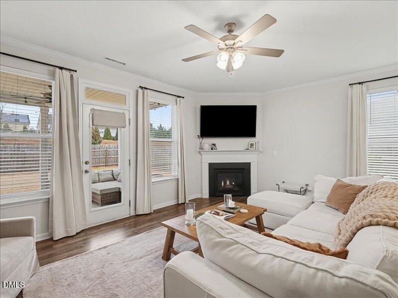 724 Summer Music Lane Raleigh, NC 27603 - Photo 20 of 70 a living room with furniture a fireplace and a flat screen tv